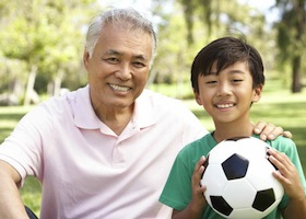 Grandson and grandpa playing soccer