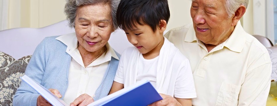 grandchild reading to his grandparents