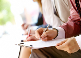 Human hand over paper making notes in working environment