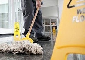 Office cleaner cleaning floor