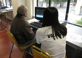 an elder getting taught to use a computer