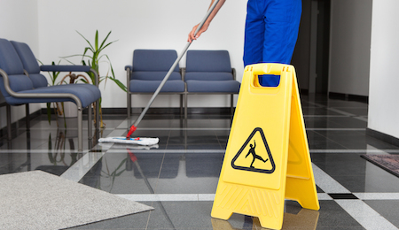 Man With Mop And Wet Floor Sign