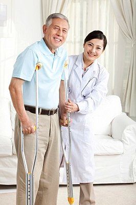 doctor assisting on walking with crutches