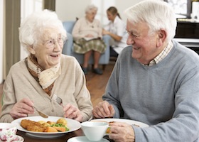 old couple eating dinner together