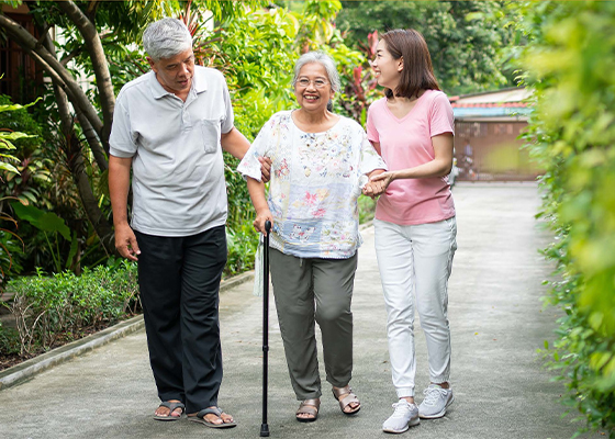 Escort walking a happy elderly woman