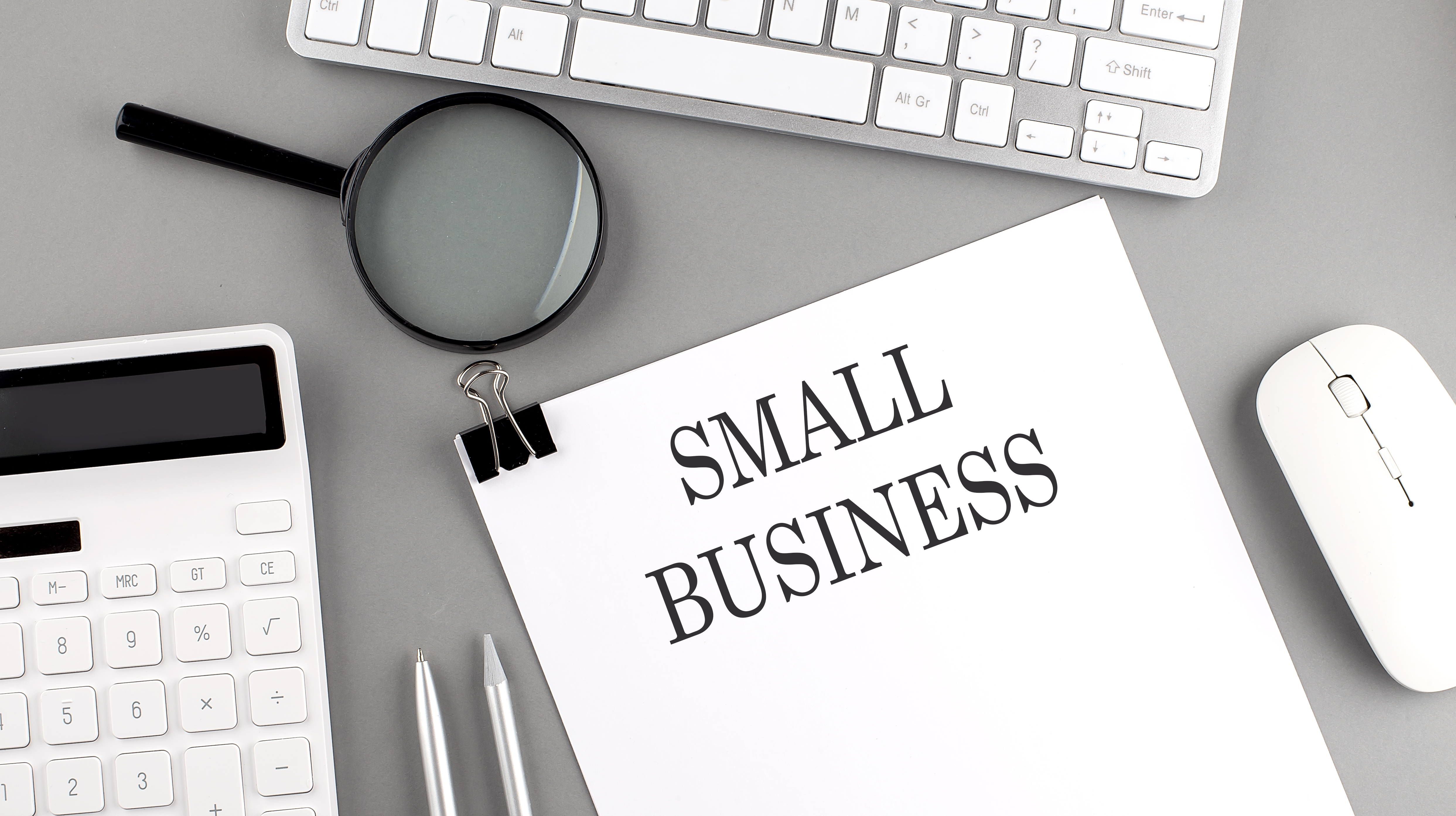 Image of a desk with a stack of papers labeled Small business